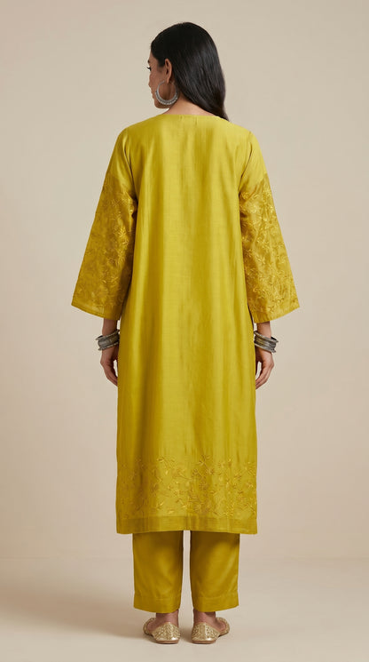 Woman wearing a yellow kurta with a plain background
