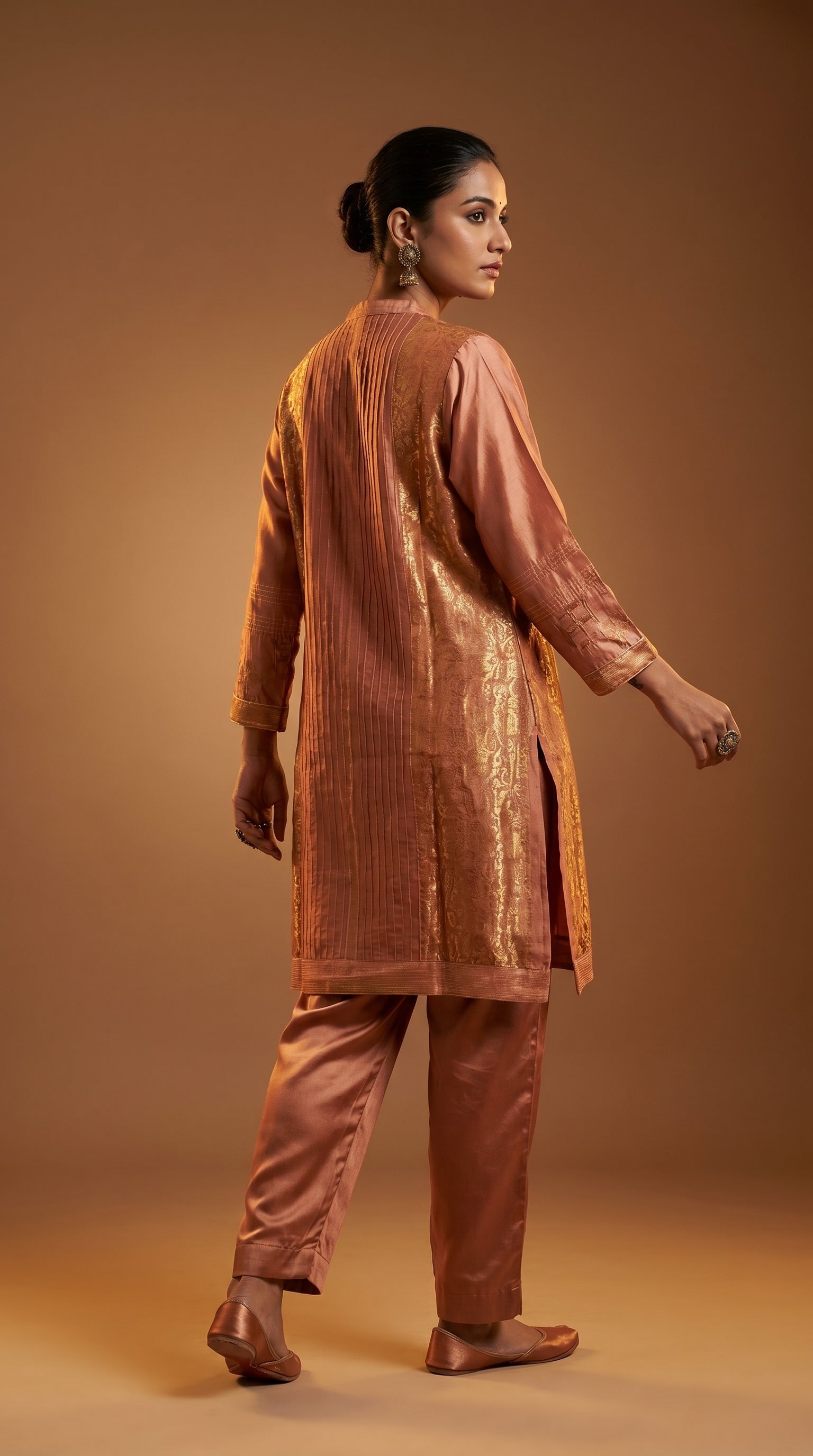 Woman wearing a brown traditional outfit against a matching background