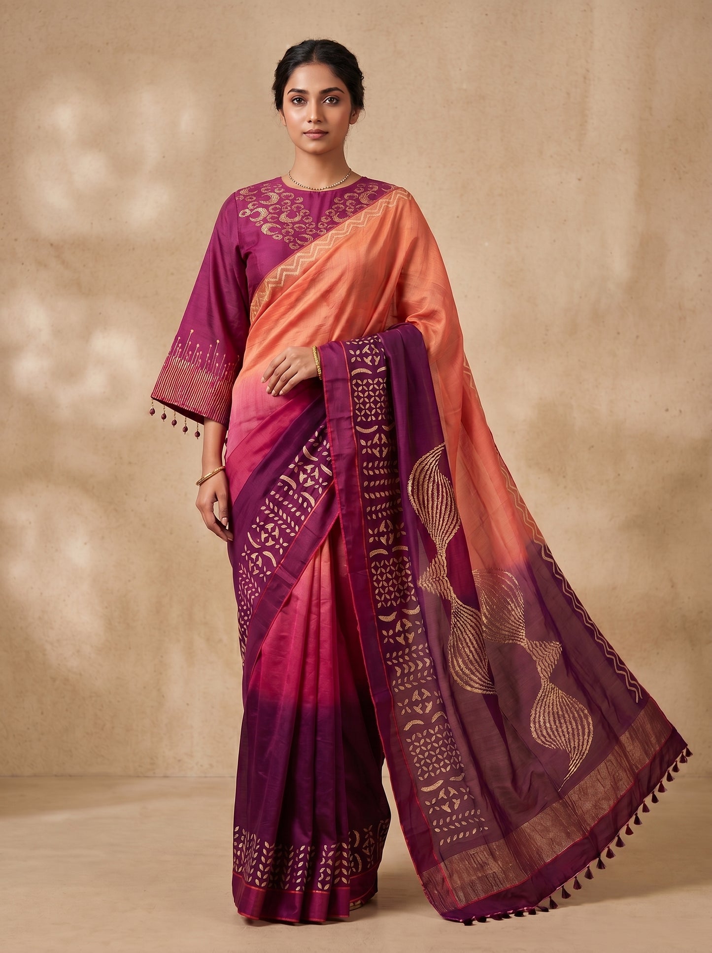 Woman wearing a traditional saree with a pink and purple gradient on a beige background