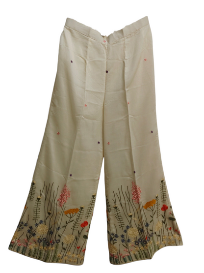 Beige plazzo with floral embroidery on a white background