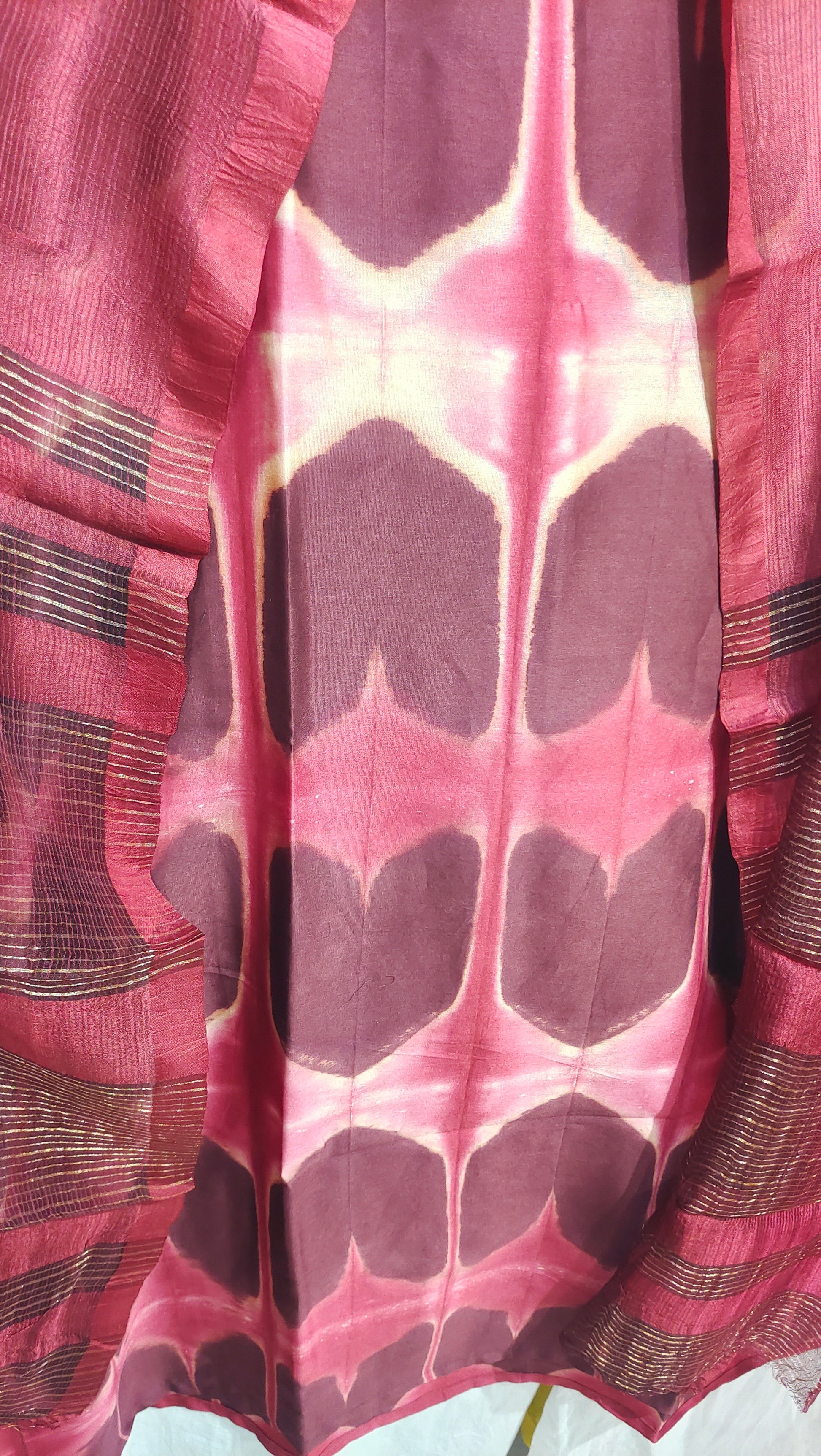Close-up of a red patterned kurta with a white background