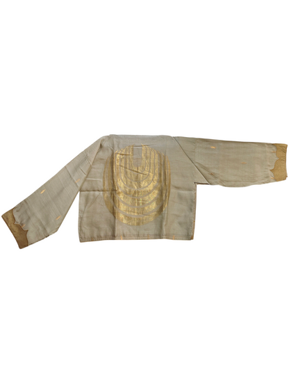 Traditional blouse with gold embroidery on a white background